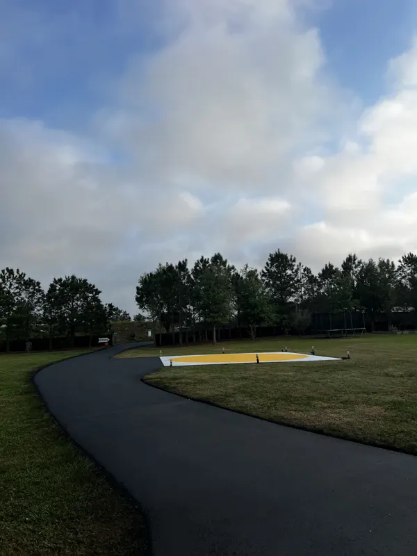 New asphalt drive sweeping past a landscaped bed
